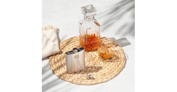 Flasque Vacu Vin à côté d’un verre et d’une bouteille de whisky