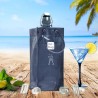 Sac rafraîchisseur Ice.Bag Classic gris fumé Smoke Grey avec une bouteille dans un décor de plage