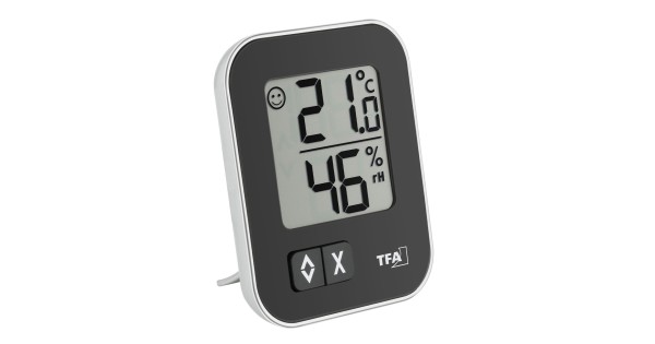 Thermo-hygromètre MOXX TFA noir posé sur son support arrière