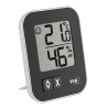 Thermo-hygromètre MOXX TFA noir posé sur son support arrière